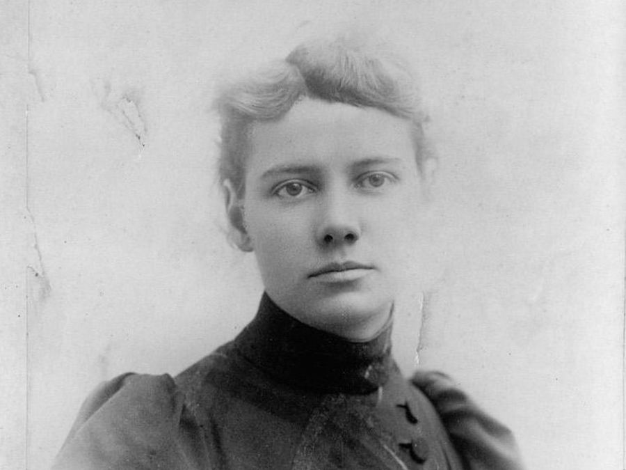 Studio portrait of Nellie Bly, about 1890, looking directly at the camera in a high-collared jacket.